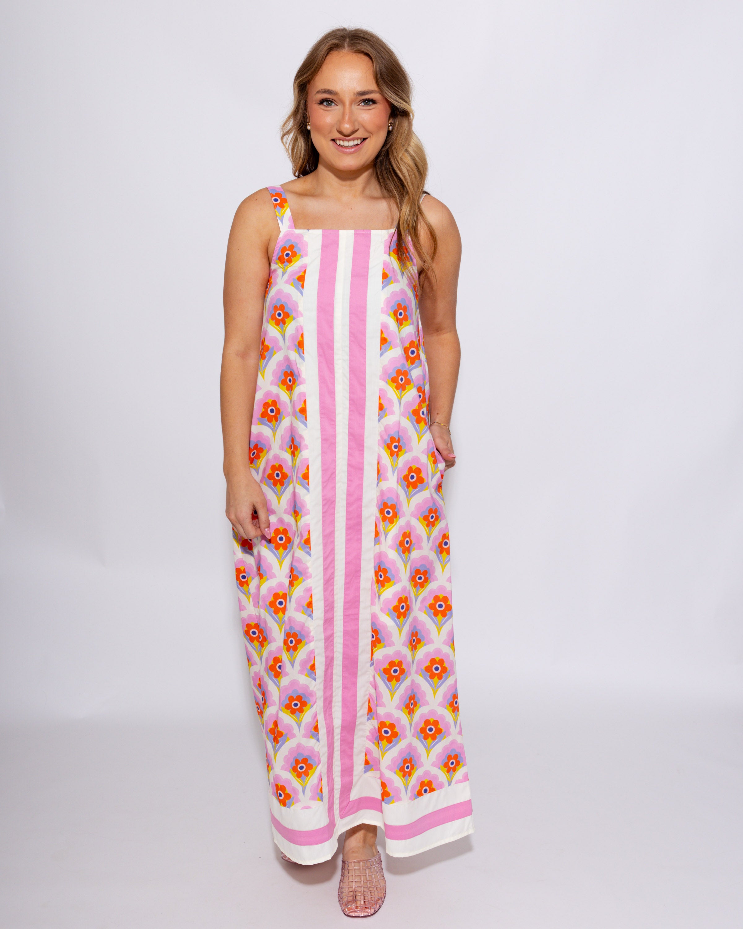 Pink and yellow floral sleeveless midi dress with scalloped detail and contrast border panel, 100% cotton with pockets at Gaudie & Co