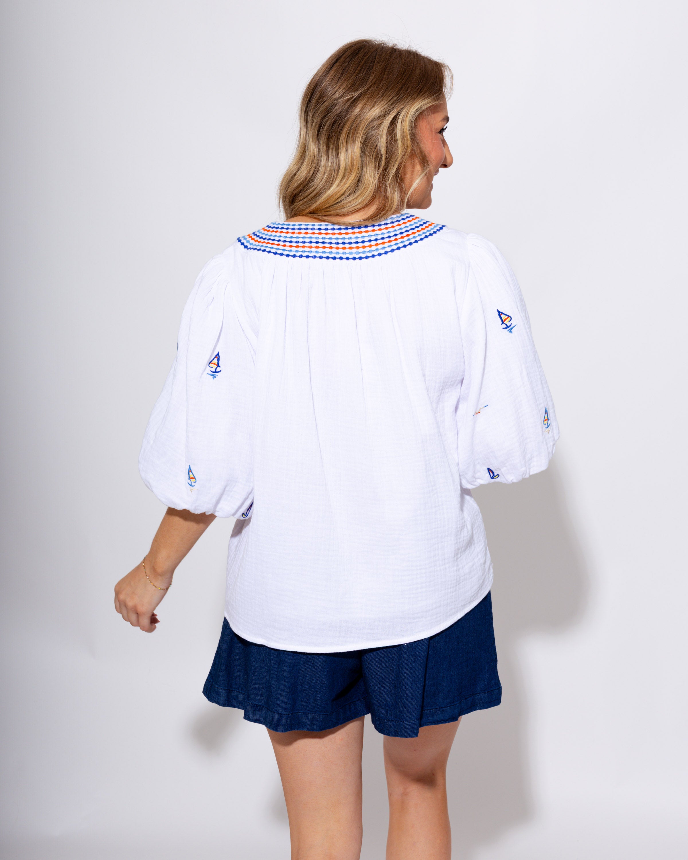 White puff sleeve top with blue and red sailboat embroidery, coastal nautical women's blouse at Gaudie & Co